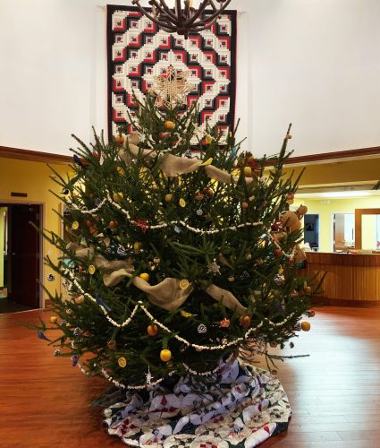 Decorated Christmas tree in a large room.