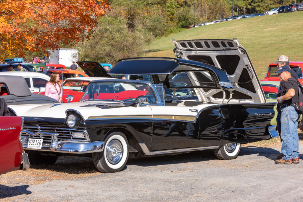 A classic convertible car painted black and white.